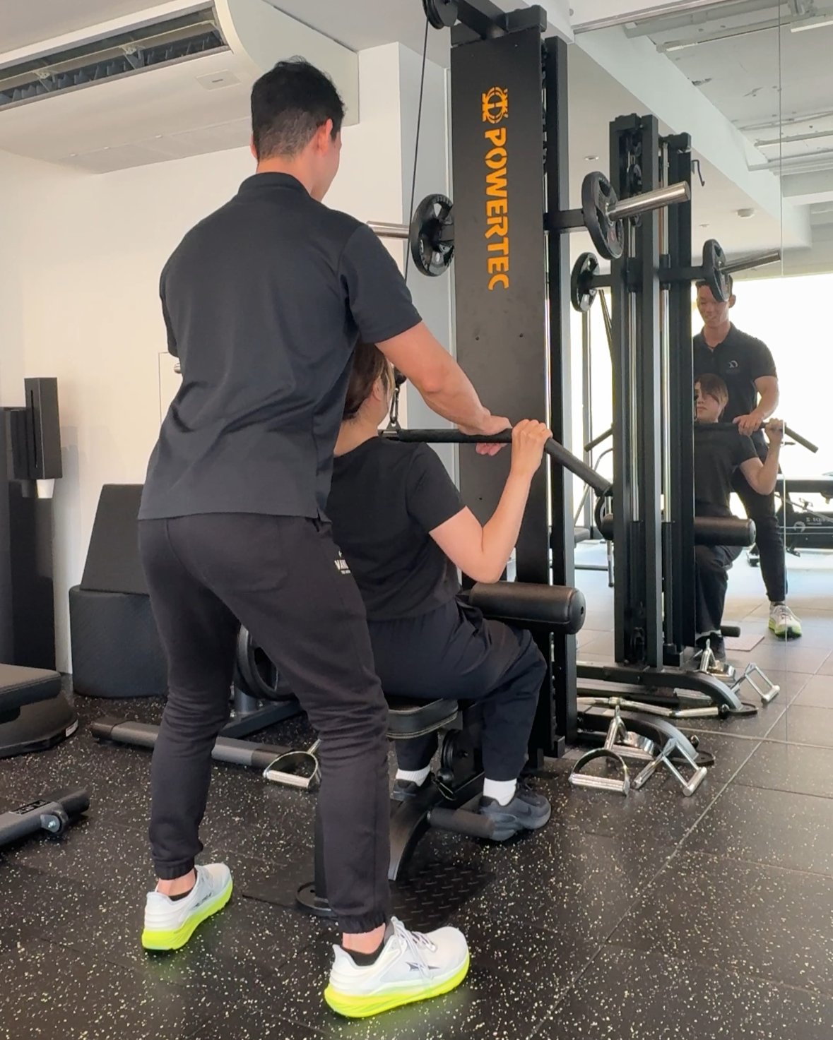 ラットプルダウンを指導するパーソナルトレーニング